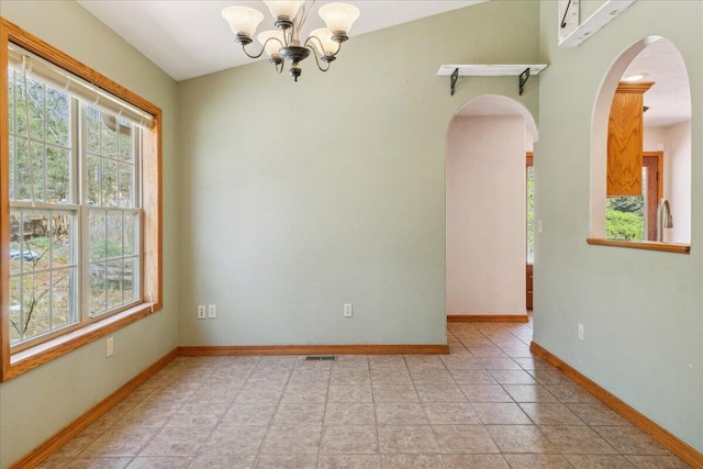 580 Cedar Hill Ln, Marshfield, MO 65706 - spare room with arched walkways, plenty of natural light, a chandelier, and baseboards