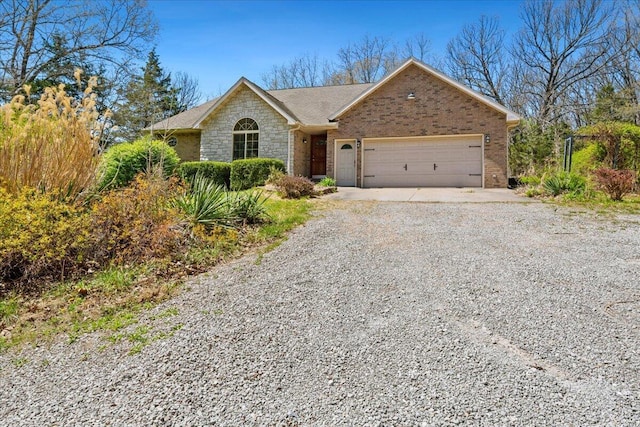 580 Cedar Hill Ln, Marshfield, MO 65706 - ranch-style home featuring gravel driveway, an attached garage, and stone siding