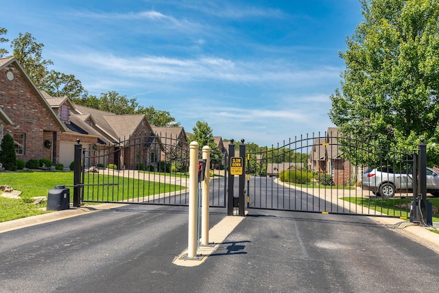 361 Stillwood Dr, Branson, MO 65616 - gate featuring a lawn and a residential view