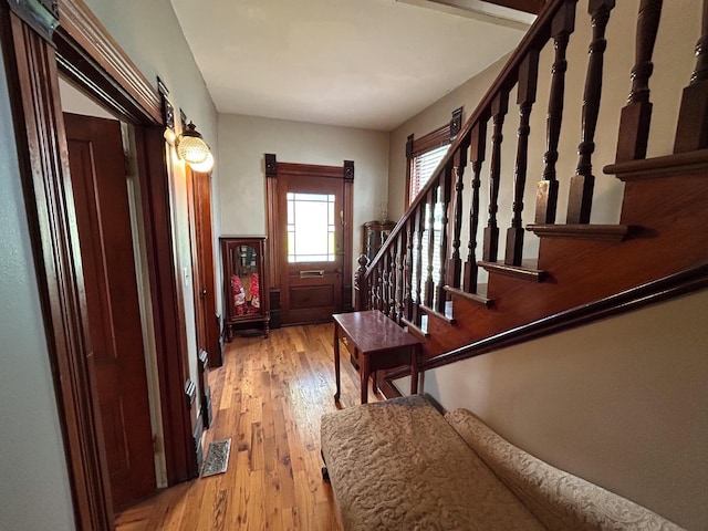 foyer with hardwood / wood-style flooring and stairs