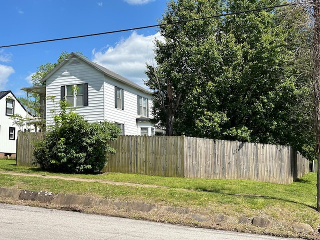 view of side of property featuring fence