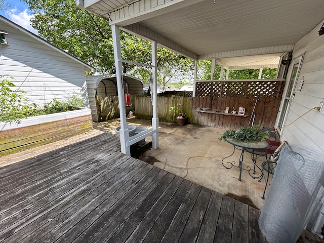 deck with fence and a storage unit