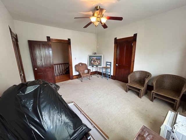 living area featuring ceiling fan and carpet floors