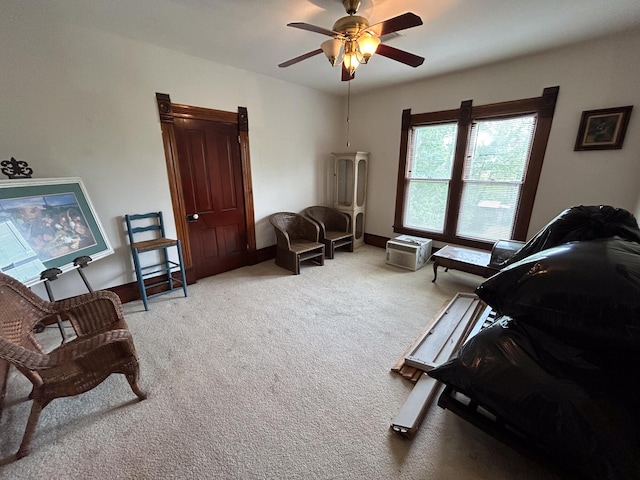 sitting room with carpet flooring and ceiling fan