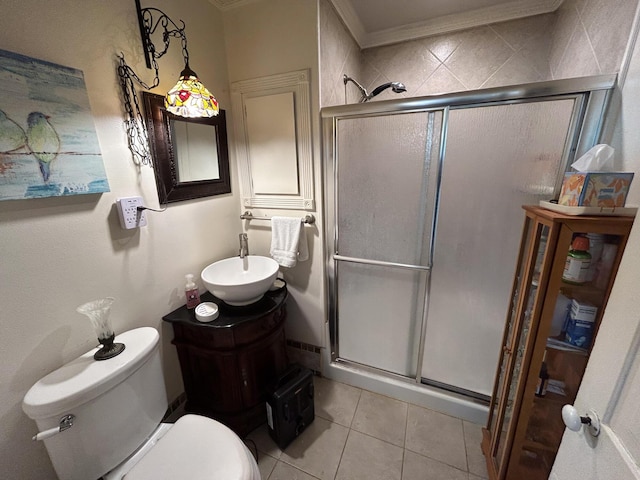 bathroom with a shower stall, toilet, tile patterned flooring, vanity, and ornamental molding