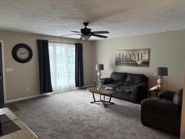 carpeted living room featuring a textured ceiling, a ceiling fan, and baseboards