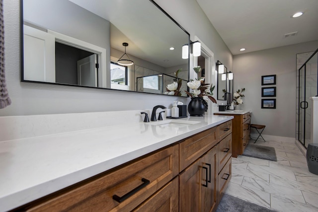 bathroom featuring a shower stall, marble finish flooring, two vanities, recessed lighting, and baseboards