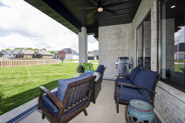 view of patio / terrace featuring ceiling fan, area for grilling, a residential view, and an outdoor living space