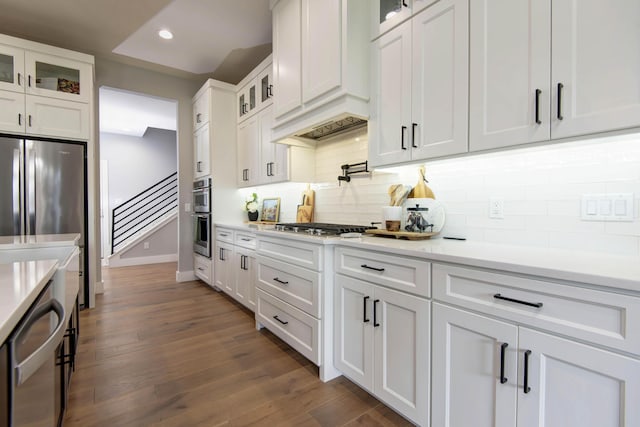kitchen with white cabinets, light countertops, dark wood-style floors, tasteful backsplash, and recessed lighting