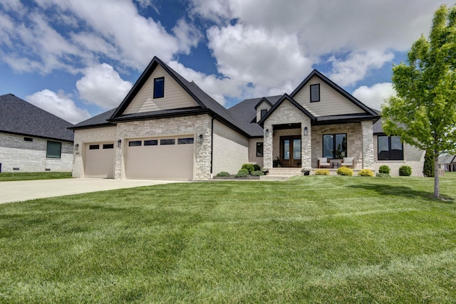 view of front facade featuring stone siding, a front yard, a garage, concrete driveway, and french doors
