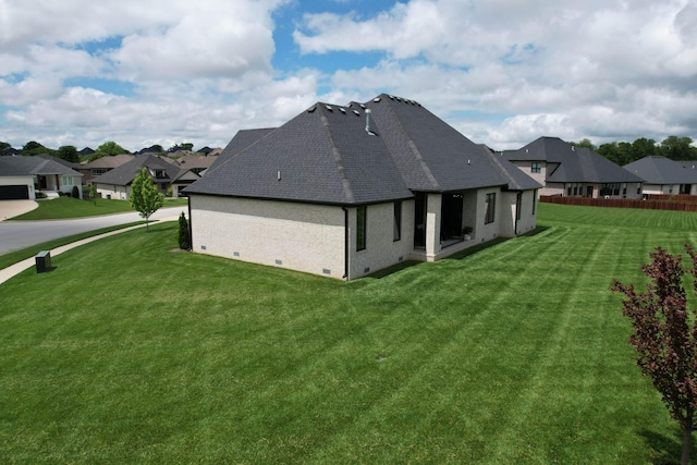 rear view of property with crawl space, roof with shingles, a residential view, and brick siding