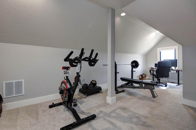 exercise area featuring lofted ceiling, baseboards, and carpet