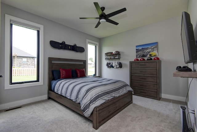 carpeted bedroom featuring baseboards and a ceiling fan