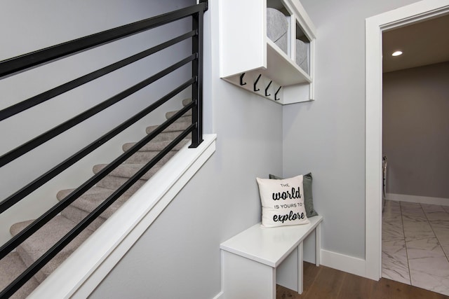 mudroom featuring dark marble finish flooring, baseboards, and recessed lighting