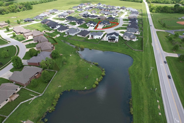 aerial view of property's location with a large body of water and nearby suburban area