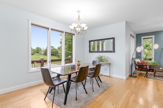 5998 S Parkhaven Ln, Springfield, MO 65810 - dining room with a chandelier, light wood-type flooring, and baseboards