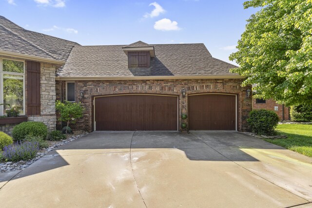 5998 S Parkhaven Ln, Springfield, MO 65810 - view of front of house with a garage, concrete driveway, brick siding, and a shingled roof