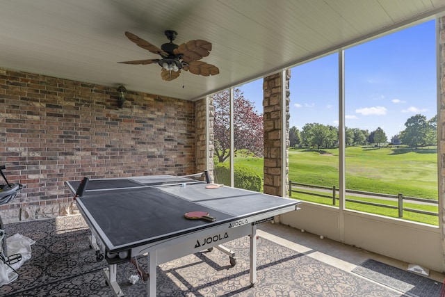 5998 S Parkhaven Ln, Springfield, MO 65810 - rec room featuring a ceiling fan, brick wall, and view of golf course
