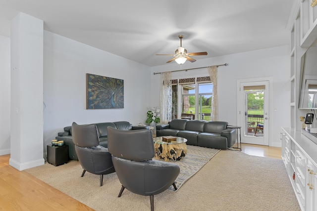 5998 S Parkhaven Ln, Springfield, MO 65810 - living area with a ceiling fan, light wood finished floors, and baseboards
