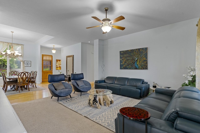 5998 S Parkhaven Ln, Springfield, MO 65810 - living room with a chandelier, ceiling fan, light wood-style flooring, light colored carpet, and baseboards