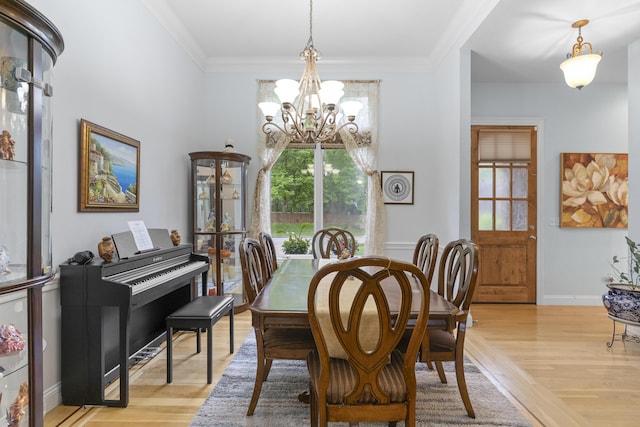 5998 S Parkhaven Ln, Springfield, MO 65810 - dining space featuring a chandelier, light wood-style floors, crown molding, and baseboards