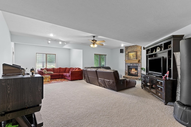 5998 S Parkhaven Ln, Springfield, MO 65810 - living room featuring light carpet, plenty of natural light, a fireplace, and a ceiling fan