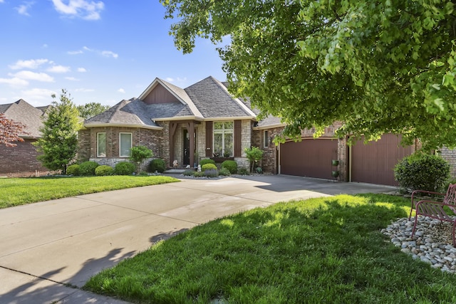 5998 S Parkhaven Ln, Springfield, MO 65810 - french country style house with concrete driveway, a front lawn, stone siding, and an attached garage
