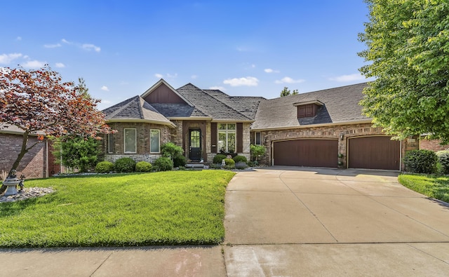 5998 S Parkhaven Ln, Springfield, MO 65810 - french provincial home with a front yard, concrete driveway, an attached garage, and stone siding