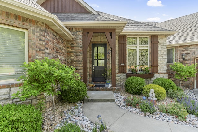 5998 S Parkhaven Ln, Springfield, MO 65810 - view of exterior entry featuring brick siding and roof with shingles