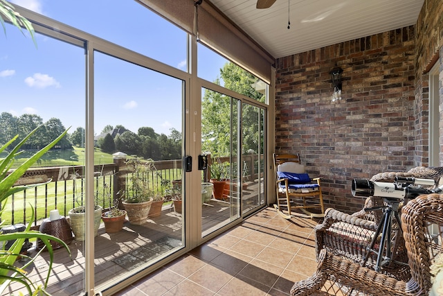 5998 S Parkhaven Ln, Springfield, MO 65810 - sunroom with brick wall, ceiling fan, and tile patterned flooring
