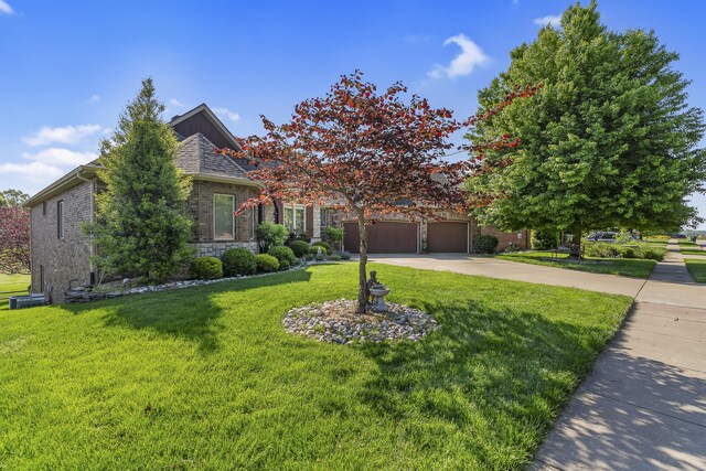 5998 S Parkhaven Ln, Springfield, MO 65810 - obstructed view of property featuring a front yard, driveway, brick siding, and stone siding