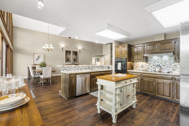 1294 Acacia Club Rd, Hollister, MO 65672 - kitchen with black appliances, butcher block counters, tasteful backsplash, a chandelier, and dark wood-type flooring