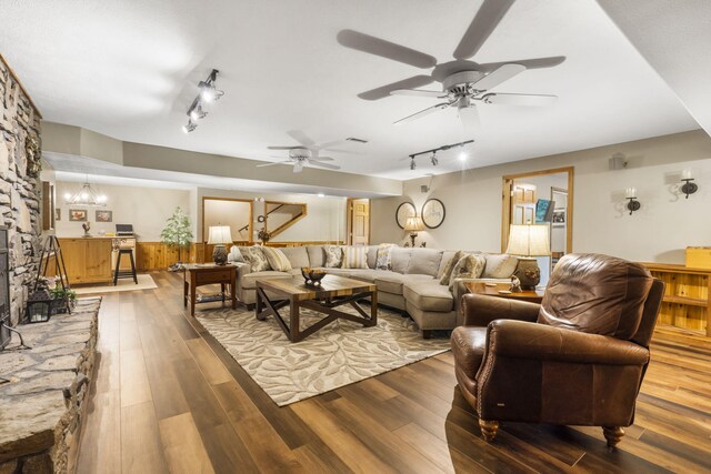 1294 Acacia Club Rd, Hollister, MO 65672 - living area with rail lighting, wood finished floors, and a ceiling fan