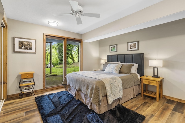 1294 Acacia Club Rd, Hollister, MO 65672 - bedroom featuring baseboards, access to exterior, wood finished floors, and a ceiling fan