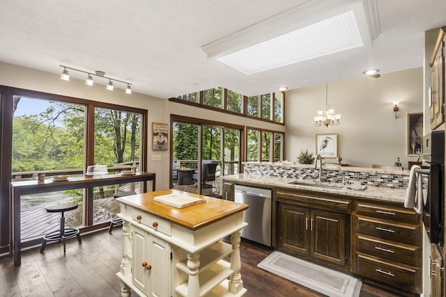 1294 Acacia Club Rd, Hollister, MO 65672 - kitchen with stainless steel dishwasher, a sink, tasteful backsplash, light stone counters, and dark wood-style floors