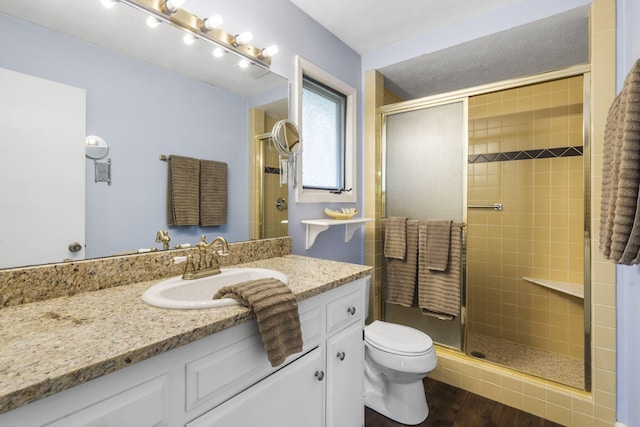 1294 Acacia Club Rd, Hollister, MO 65672 - bathroom featuring toilet, a shower stall, wood finished floors, and vanity