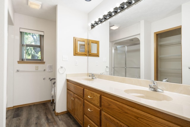 170 Sundance Rd, Cape Fair, MO 65624 - bathroom featuring wood finished floors, a shower stall, double vanity, and baseboards