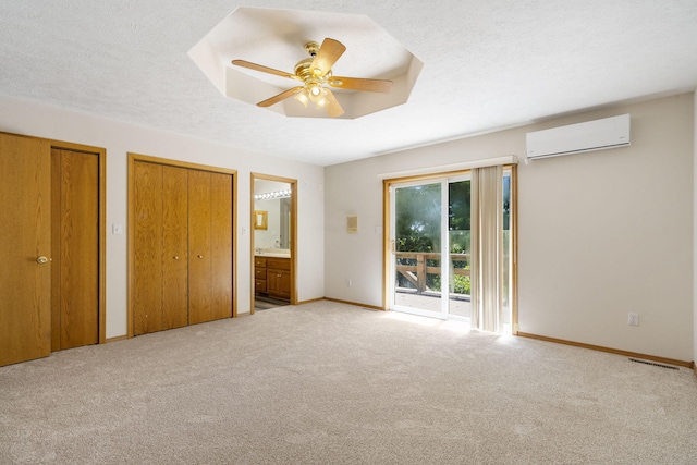 170 Sundance Rd, Cape Fair, MO 65624 - unfurnished bedroom with a wall mounted AC, access to exterior, two closets, baseboards, and carpet floors