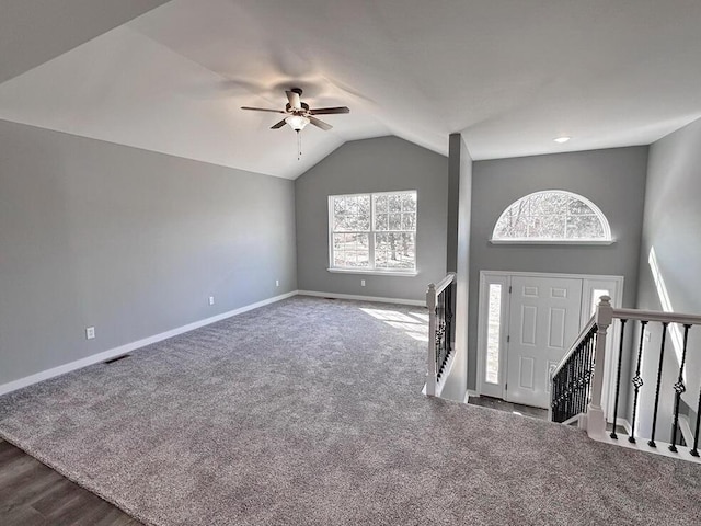1712 S Jackson St, El Dorado Springs, MO 64744 - entrance foyer featuring ceiling fan, baseboards, vaulted ceiling, and dark carpet