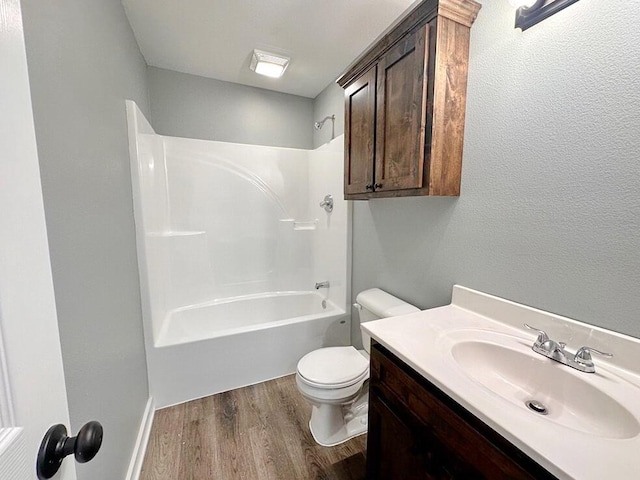 1712 S Jackson St, El Dorado Springs, MO 64744 - full bathroom featuring wood finished floors, toilet, vanity, and shower / tub combination