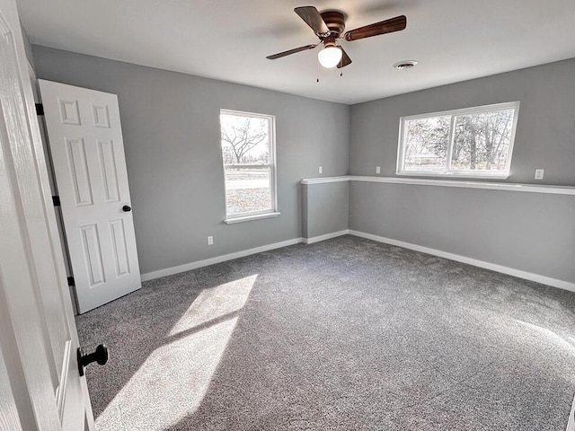 1712 S Jackson St, El Dorado Springs, MO 64744 - unfurnished bedroom featuring carpet flooring, baseboards, and ceiling fan