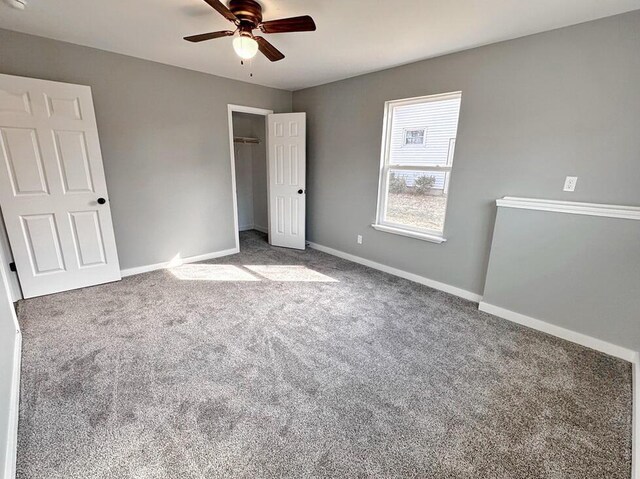 1712 S Jackson St, El Dorado Springs, MO 64744 - unfurnished bedroom with carpet, baseboards, a closet, and ceiling fan