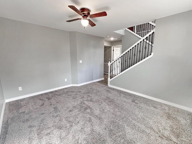 1712 S Jackson St, El Dorado Springs, MO 64744 - unfurnished living room with a ceiling fan, baseboards, carpet floors, and stairs