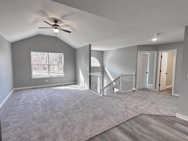 1712 S Jackson St, El Dorado Springs, MO 64744 - unfurnished living room featuring baseboards, ceiling fan, wood finished floors, and vaulted ceiling