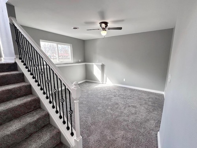 1712 S Jackson St, El Dorado Springs, MO 64744 - stairs featuring a ceiling fan, carpet flooring, and baseboards