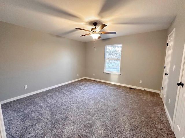 1712 S Jackson St, El Dorado Springs, MO 64744 - spare room with a ceiling fan, dark colored carpet, and baseboards