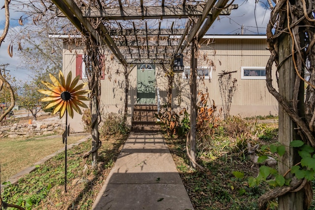 property entrance with a pergola