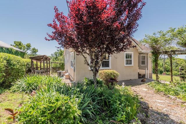 237 Jefferson St, Forsyth, MO 65653 - view of home's exterior featuring stucco siding and central AC unit