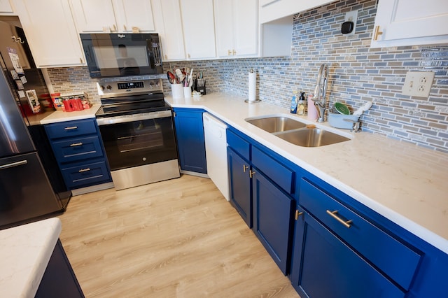 21246 County Road 295, Hermitage, MO 65668 - kitchen featuring black appliances, blue cabinetry, a sink, white cabinetry, and tasteful backsplash