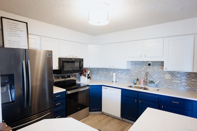 21246 County Road 295, Hermitage, MO 65668 - kitchen featuring appliances with stainless steel finishes, blue cabinetry, a sink, light wood-style floors, and light countertops